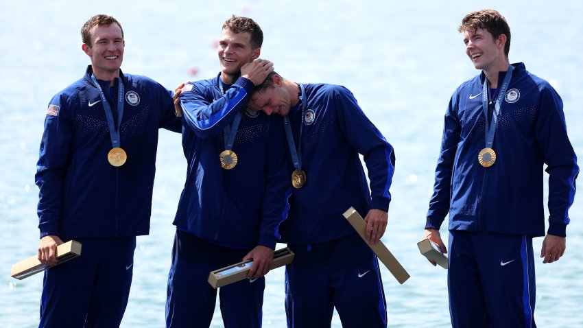 Gold medalists Nick Mead, Justin Best, Michael Grady and Liam Corrigan of Team United States celebrate on the podium at the Rowing Men's Four medal ceremony.