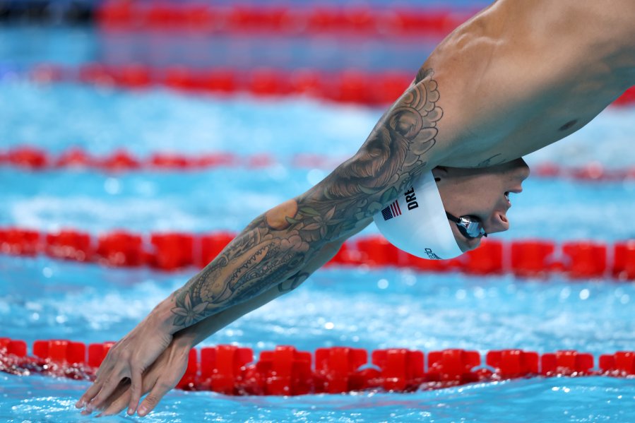 Caeleb Dressel dives into the pool