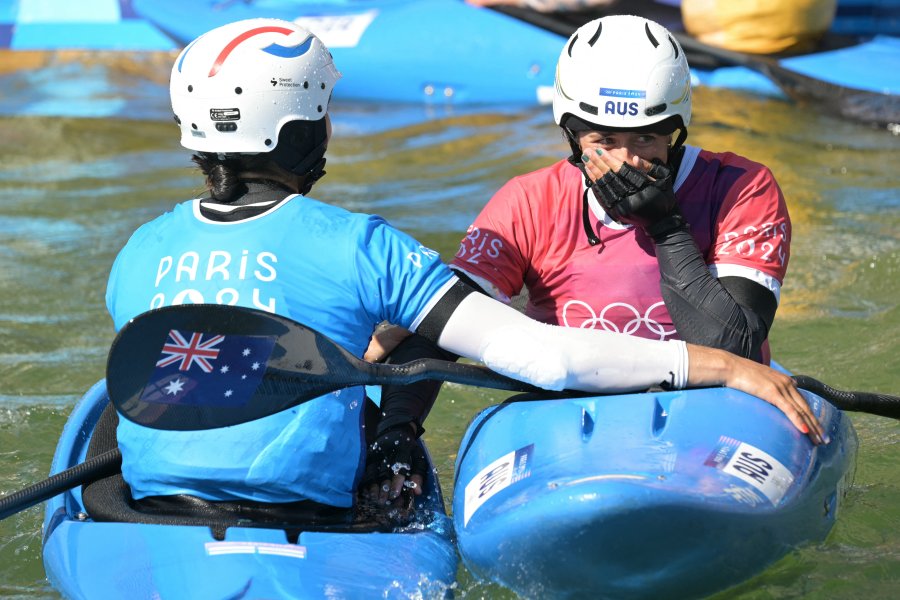 Australia's gold medallist Noemie Fox and France's silver medallist Angele Hug celebrate after the women's kayak cross final of the canoe slalom competition at Vaires-sur-Marne Nautical Stadium in Vaires-sur-Marne during the Paris 2024 Olympic Games on August 5, 2024