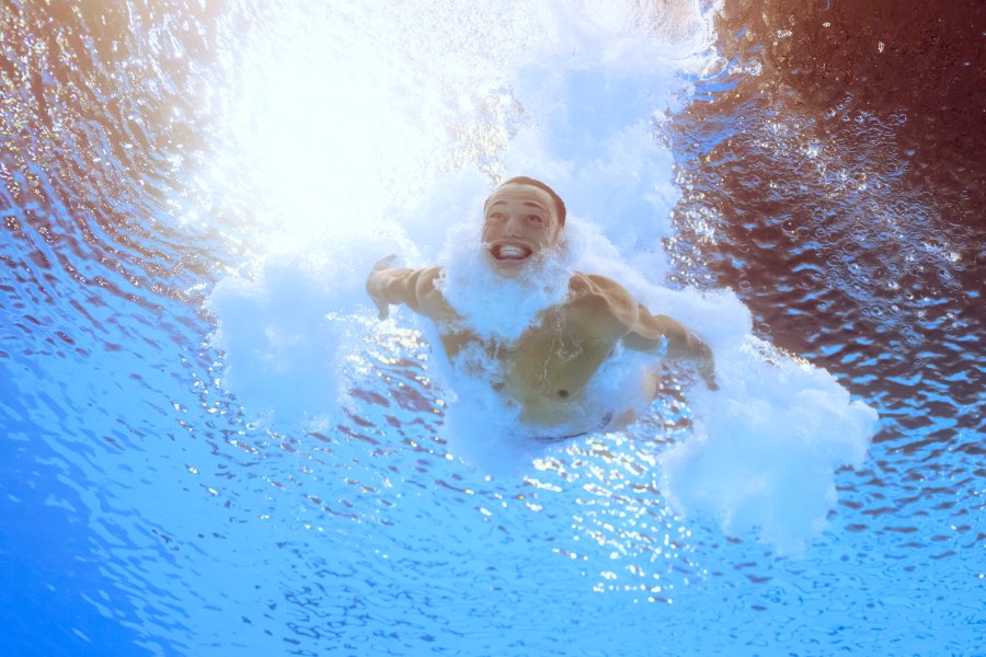 An underwater view shows Britain's Jordan Christopher Houlden competing in the men's 3m springboard diving preliminary during the Paris 2024 Olympic Games at the Aquatics Centre in Saint-Denis, north of Paris, on August 6, 2024