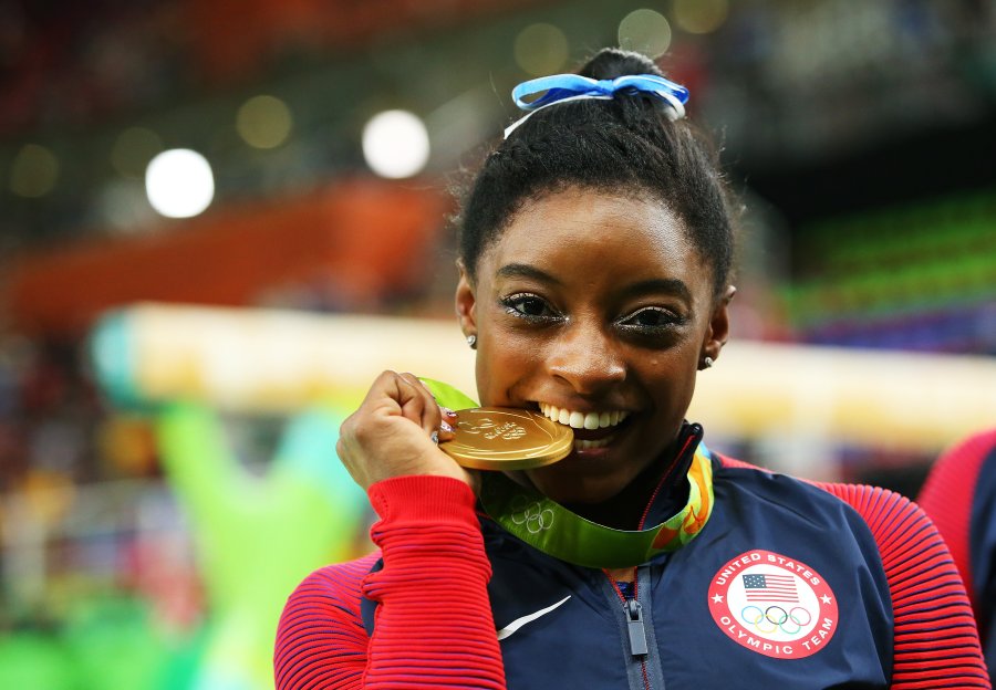 Biles bites her gold medal