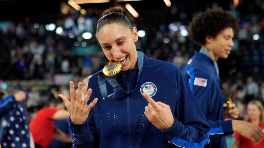 Aug 11, 2024; Paris, France; United States shooting guard Diana Taurasi (12) celebrates after the receiving the gold medal in women’s basketball during the Paris 2024 Olympic Summer Games at Accor Arena. Mandatory Credit: Kyle Terada-USA TODAY Sports