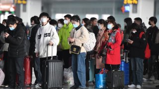 Passengers wait at Fuyang West Railway Station in China on Feb. 15, 2023.