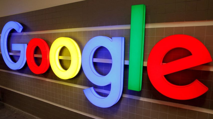 An illuminated Google logo is seen inside an office building in Zurich, Switzerland.