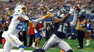 Ryan Flournoy, #18 of the Dallas Cowboys, catches a touchdown pass as Matt Hankins, #23 of the Los Angeles Chargers, defends during the first half of a preseason game at AT&T Stadium in Arlington, Texas, on Aug. 24, 2024.