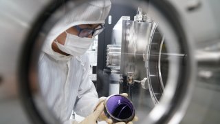 BEIJING, CHINA – MAY 26: A researcher deals with a wafer arrayed with carbon nanotubes (CNT) at a laboratory on May 26, 2020 in Beijing, China. (Photo by VCG/VCG via Getty Images)