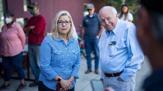 Liz Cheney arrives with her father, former Vice President Dick Cheney, to vote at the Teton County Library during the Republican primary election, in Jackson Hole, Wyoming, on Aug 16, 2022.