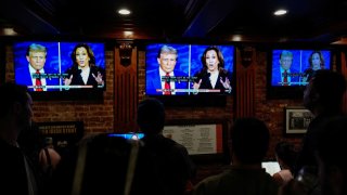 People watch the presidential debate between Republican presidential nominee and former U.S. President Donald Trump and Democratic presidential nominee and U.S. Vice President Kamala Harris at a watch party hosted by the New York Young Republican Club, in New York City, U.S., September 10, 2024. 