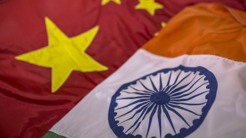 A Chinese national flag, left, and an Indian national flag are arranged for a photograph.