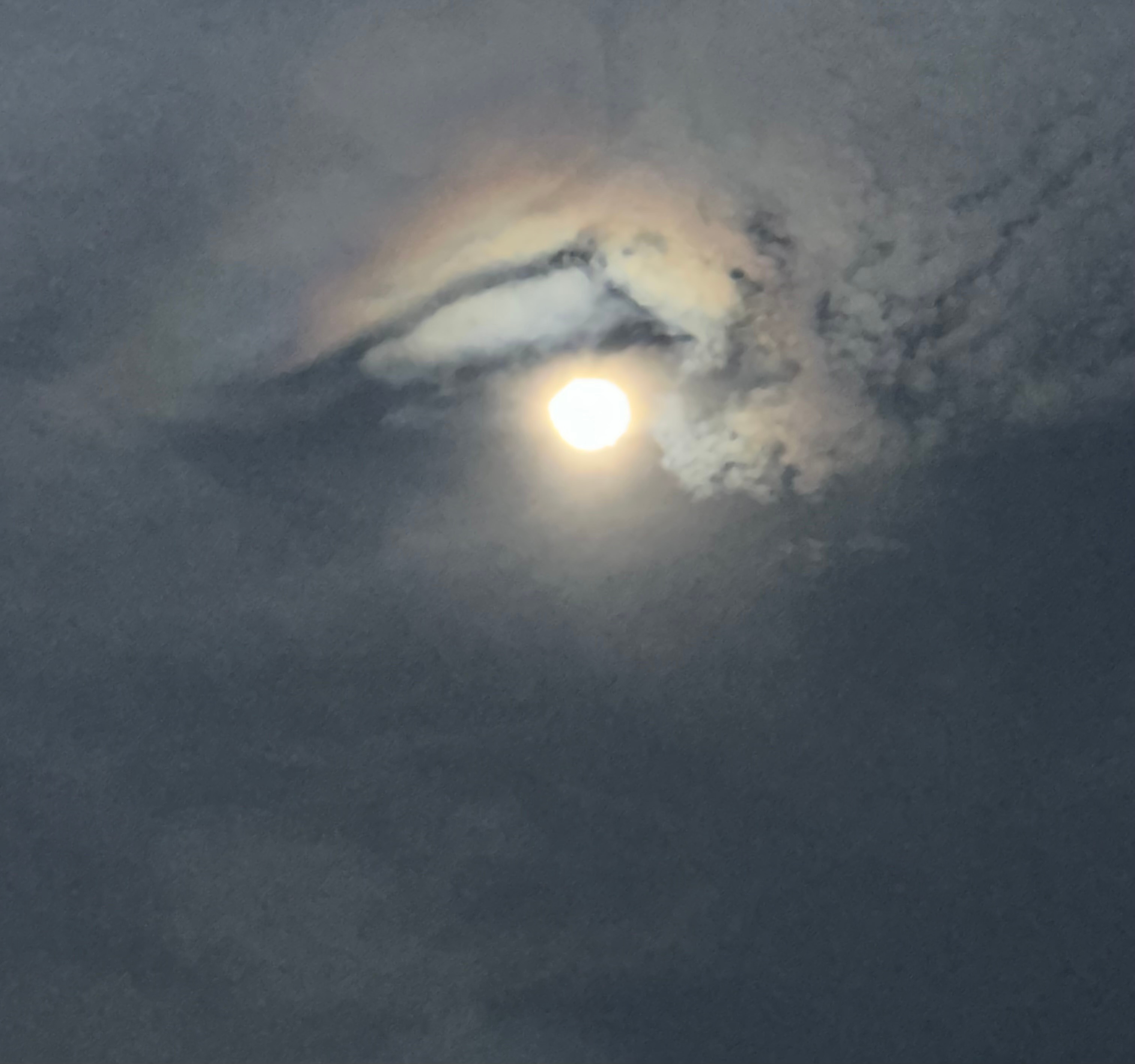 Eclipse shows a face from clouds around