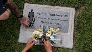 Mikayla Brown and her husband, Tyler, visit the grave of their son, Elijah, who died of a fentanyl overdose at 15, in Paso Robles, Calif., Friday, Aug. 2, 2024.