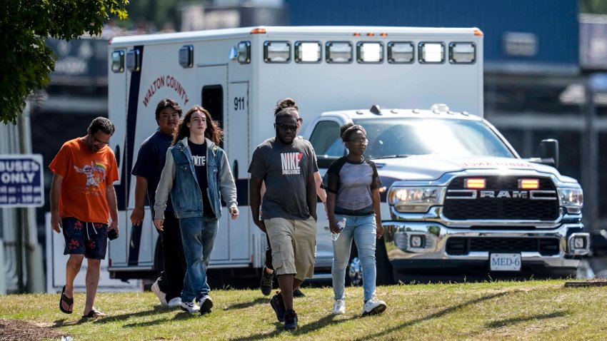 Students and parents walk off campus at Apalachee High School