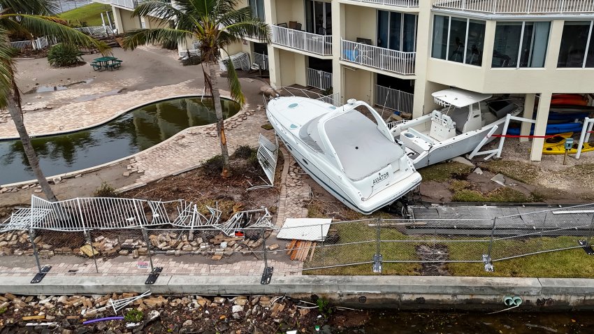 Boats sit after being pushed ashore by floodwaters