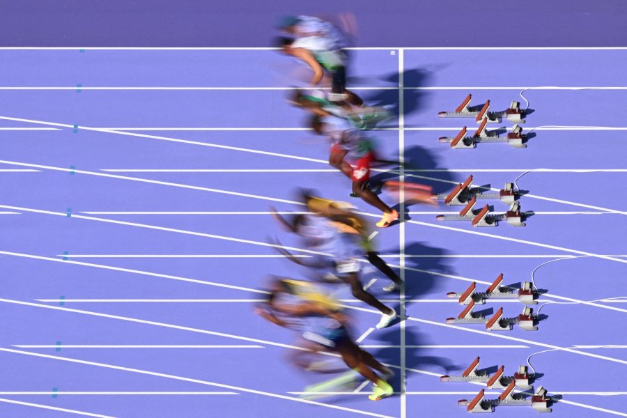 An overview shows athletes taking the start of a heat of the men's 100m T11 during the Paris 2024 Paralympic Games at the Stade de France in Saint-Denis outside Paris on September 4 2024