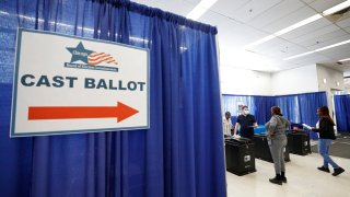 Voters cast their ballots on the second day of early voting in the 2024 presidential election at the Board of Elections Loop Super Site in Chicago, Illinois, on October 4, 2024. 