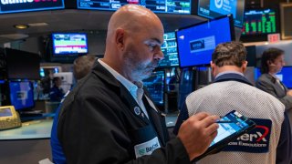 NEW YORK, NEW YORK – OCTOBER 16: Traders and others work on the New York Stock Exchange (NYSE) floor in New York City. 