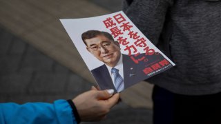 Amember of staff hands flyers with picture of Japan’s Prime Minister Shigeru Ishiba before his election campaign speech in Tokyo on October 26, 2024. 