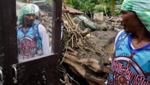 Marcelino Aringo speaks near his damaged house after a landslide triggered by Tropical Storm Trami struck homes, leaving several villagers dead in Talisay, Batangas province, Philippines on Saturday, Oct. 26, 2024. (AP Photo/Aaron Favila)