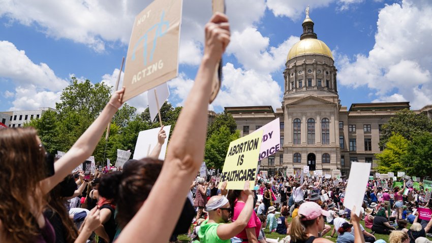 Activists rally outside the State Capitol in support of abortion rights in Atlanta, Georgia on May 14, 2022. – Thousands of activists are participating in a national day of action calling for safe and legal access to abortion. The nationwide demonstrations are a response to leaked draft opinion showing the US Supreme Court’s conservative majority is considering overturning Roe v. Wade, the 1973 ruling guaranteeing abortion access.