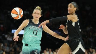 A'ja Wilson #22 of the Las Vegas Aces passes the ball up the court against Leonie Fiebich #13