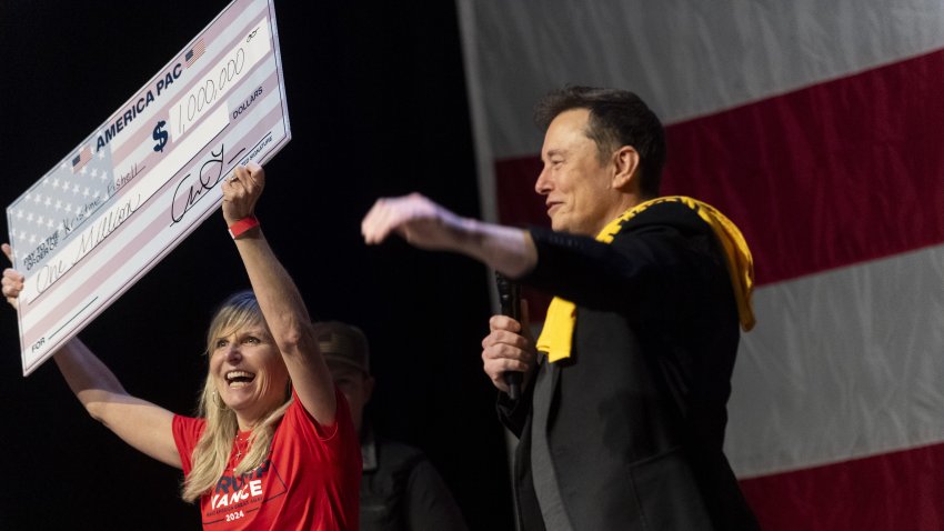 Elon Musk awards Kristine Fishell with a $1 million check