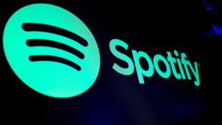 The Spotify logo is displayed on a screen on the floor of the New York Stock Exchange on Dec. 4, 2023.