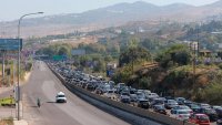 Vehicles wait in traffic in the town of Damour, south of the capital Beirut on September 24, 2024, as people flee southern Lebanon. 