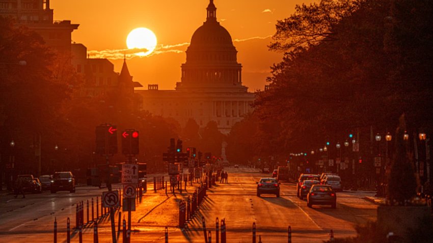 Sunrise behind the U.S. Capitol building illuminates Pennsylvania Avenue early in the morning on October 26, 2024, in Washington, DC. 