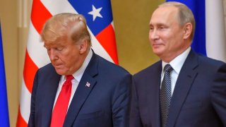 Donald Trump (L) and Russia’s Vladimir Putin arrive to attend a joint press conference after a meeting at the Presidential Palace in Helsinki, on July 16, 2018. 