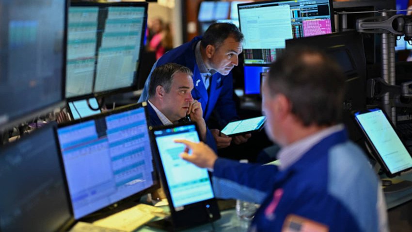 Traders work on the floor of the New York Stock Exchange during the opening bell on Nov. 13, 2024.