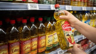 A person holds a bottle of olive oil on June 21, 2024, in Barcelona, Catalonia, Spain.