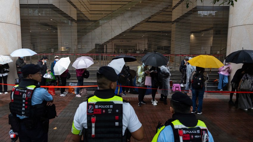 People wait outside the West Kowloon Magistrates' Courts