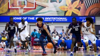 UConn forward Jaylin Stewart, center, grabs the loose ball against Colorado during the second half of an NCAA college basketball game at the Maui Invitational Tuesday, Nov. 26, 2024, in Lahaina, Hawaii. Colorado won 73-72.