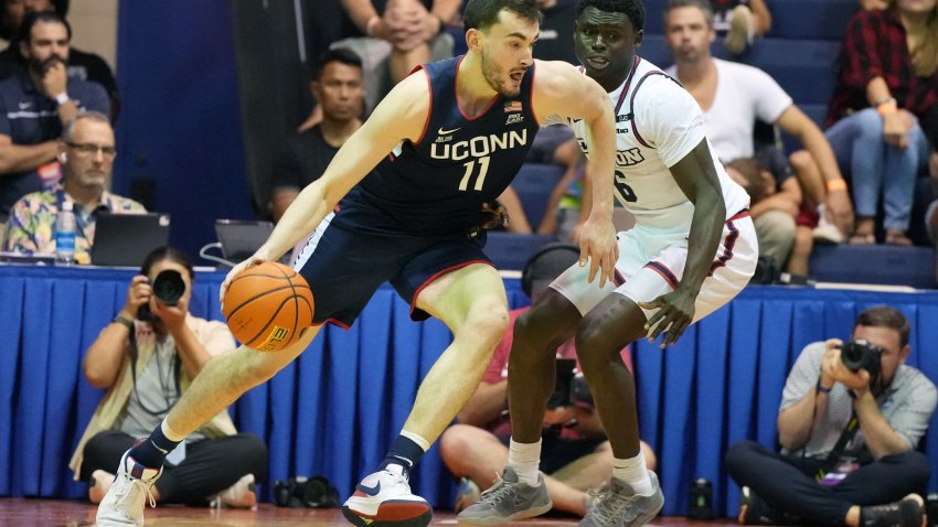 LAHAINA, HI –  NOVEMBER 27:  Alex Karaban #11 of the Connecticut Huskies drives to the basket against Enoch Cheeks #6 of the Dayton Flyers in the second half during a Maui Invitational college basketball game at The Lahaina Civic Center on November 27, 2024 in Lahaina, Hawaii.