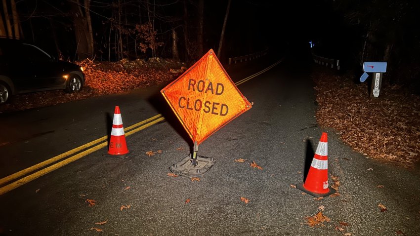 A roadblock in place as crews battle a brush fire in Roxbury.