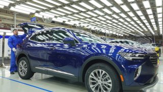 Employees work on Buick Envision SUVs at General Motors’ Dong Yue assembly plant, officially known as SAIC-GM Dong Yue Motors Co., Ltd., on Nov. 17, 2022, in Yantai, Shandong Province of China.