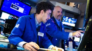 Traders work on the floor of the New York Stock Exchange on Nov. 22, 2024.