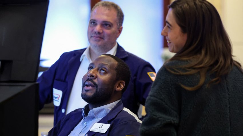 Traders work on the floor at the New York Stock Exchange (NYSE) in New York City, U.S., November 29, 2024. 