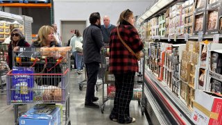 Customers shop for groceries at a Costco store on December 11, 2024 in Novato, California. 