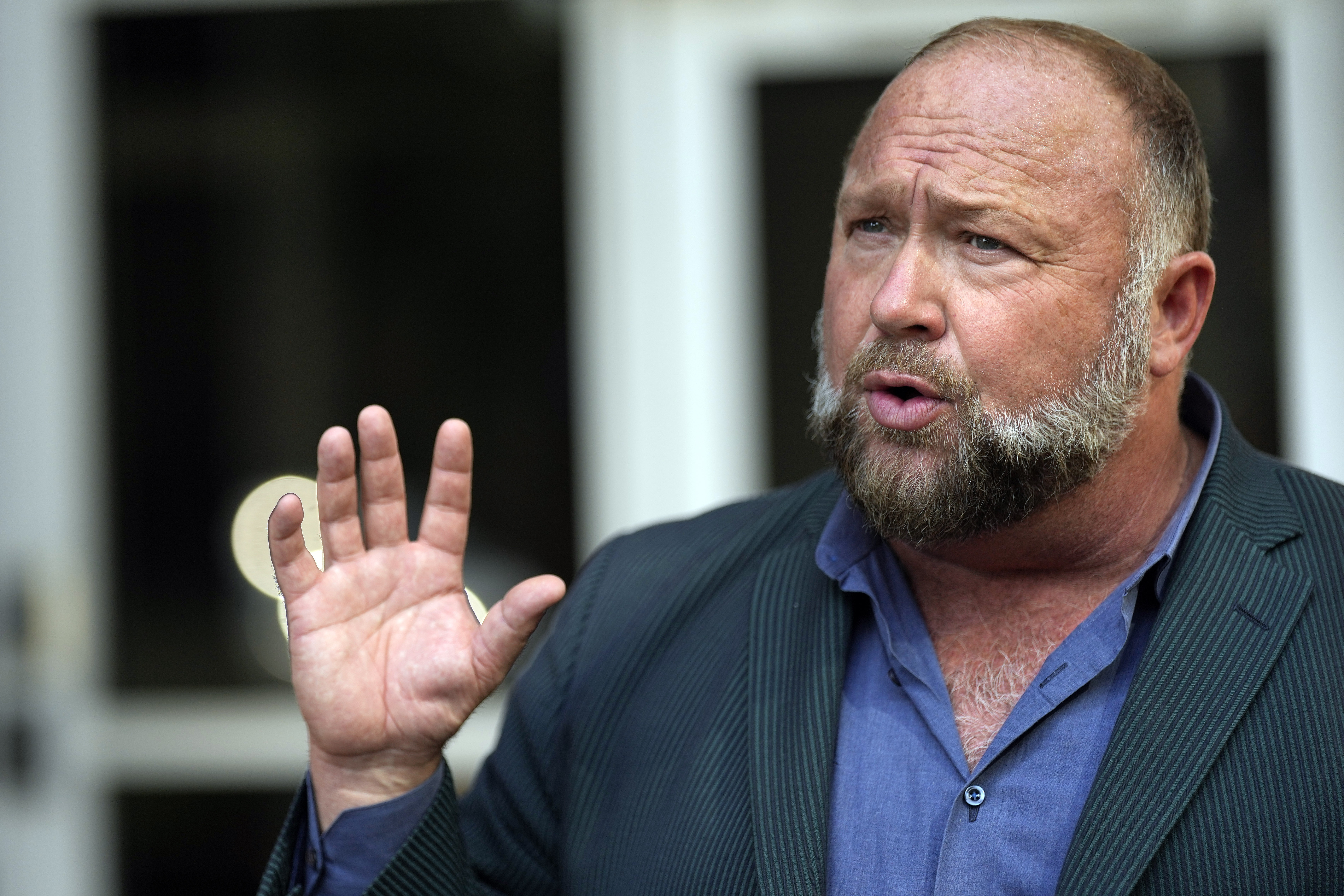 FILE – Right-wing conspiracy theorist Alex Jones speaks outside the federal courthouse after a bankruptcy hearing Friday, June 14, 2024, in Houston.