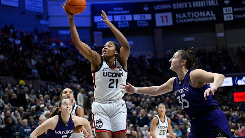 UConn forward Sarah Strong (21) grabs a rebound in the second half of an NCAA college basketball game against Holy Cross, Tuesday, Dec. 3, 2024, in Storrs, Conn.