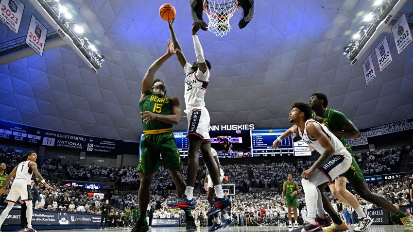 UConn center Samson Johnson (35) blocks a shot by Baylor forward Norchad Omier (15) in the first half of an NCAA college basketball game, Wednesday, Dec. 4, 2024, in Storrs, Conn.