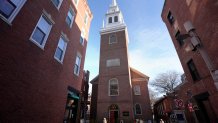 Passers-by walk near Old North Church, center, Wednesday, Dec. 18, 2024, in Boston. (AP Photo/Steven Senne)