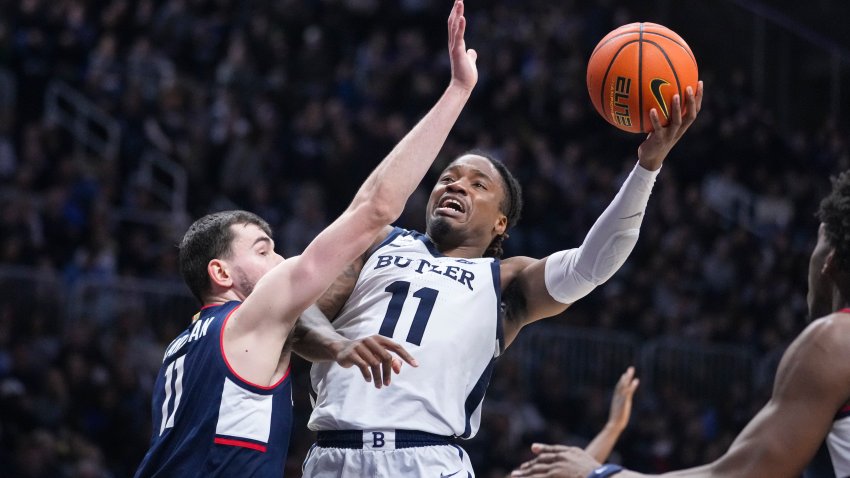 Butler forward Jahmyl Telfort (11) shoots over Connecticut forward Alex Karaban (11) in the second half of an NCAA college basketball game in Indianapolis, Saturday, Dec. 21, 2024.