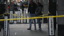 Police cover evidence with paper cups as as CEO of UnitedHealthcare Brian Thompson, 50, was shot as he entered the New York Hilton after 6:45am on December 4, 2024 in New York. The chief executive of one of the United States's largest health insurance companies, UnitedHealthcare, was shot and killed outside a New York Hilton hotel in an apparently targeted hit Wednesday, US media reported. (Photo by Bryan R. SMITH / AFP) (Photo by BRYAN R. SMITH/AFP via Getty Images)