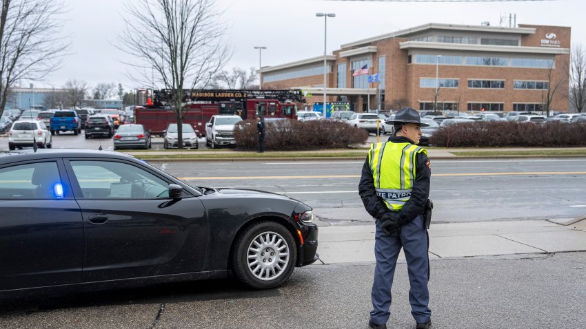 MADISON, WISCONSIN – DECEMBER 16: Law enforcement stand near a health care clinic where students from Abundant Life Christian School will be reunited withe their parents after a school shooting on December 16, 2024 in Madison, Wisconsin. According to authorities, a juvenile opened fire in the school killing at least two and injuring at least six more people. The suspect was found dead inside the school by police.  (Photo by Andy Manis/Getty Images)