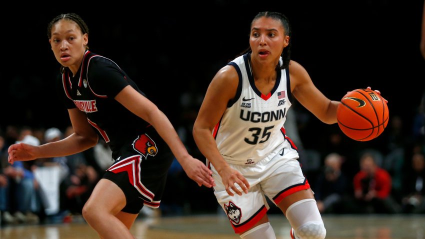 UConn guard Azzi Fudd, right, dribbles around Louisville guard Imary Berry, left, during the first half of an NCAA college basketball game Saturday, Dec. 7, 2024, in New York. (AP Photo/John Munson)