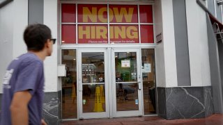 A ”Now Hiring” sign hangs above the entrance to a McDonald’s restaurant in Miami Beach, Florida.