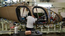 A Joby Aviation employees works on the assembly of an "electric vertical takeoff and landing" eVTOL aircraft in Marina, Calif. on Monday, Oct. 7, 2024. (AP Photo/Terry Chea)