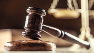 A gavel in front of scales of justice
